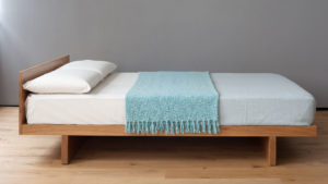 Our low solid wood Japanese style kumo bed shown in Cherry wood
