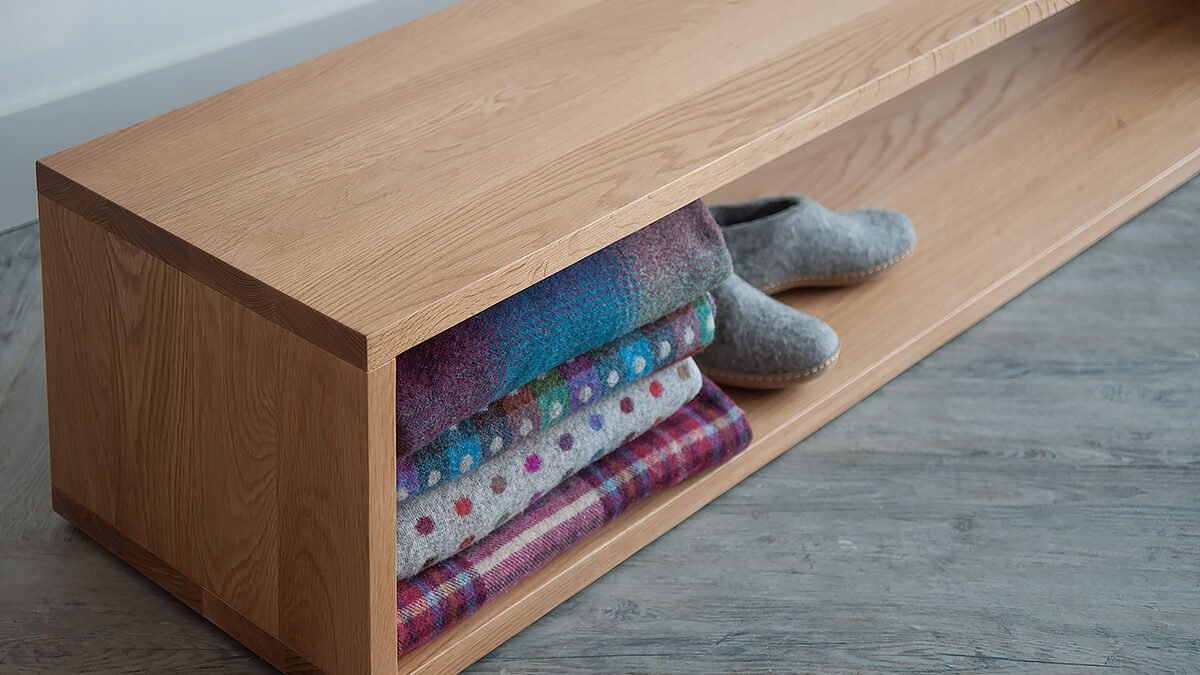 A close up view of the Black Lotus end-of-bed storage bench in Oak wood