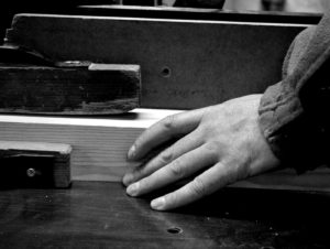 Our craftsmen working on a piece of timber