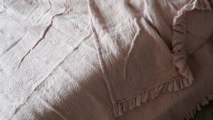 crinkle texture ruffle edged cotton bedspread in blush pink