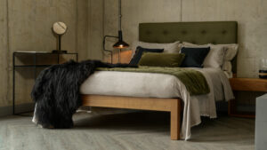 The Skye bed made in walnut with a tall buttoned wool-upholstered headboard autumnal bedroom look
