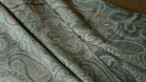 Paisley patterned merino wool throw in muted aqua tones