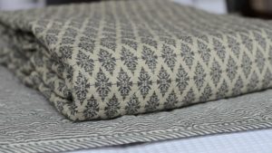 black-diamond-quilted-throw-on-striped-throw