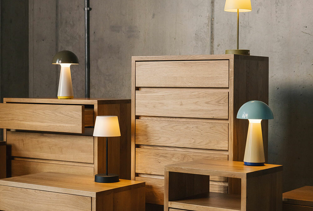 Black Lotus solid oak bedroom storage chests in a range of sizes shown with our colourful table lights