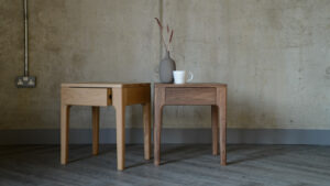 solid wood bedside tables with storage drawer shown in oak and walnut