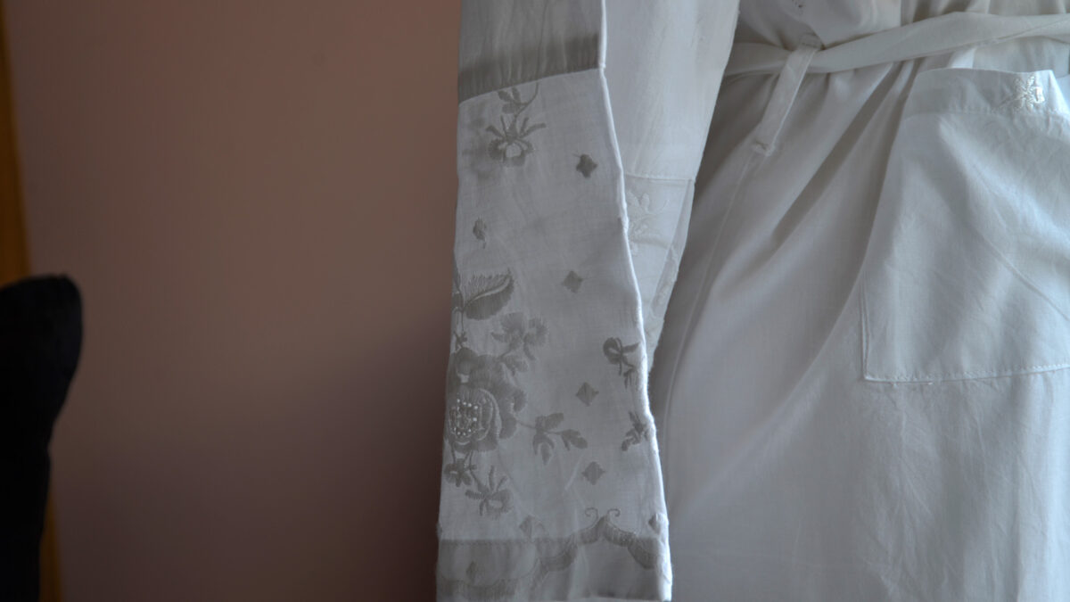 traditional white cotton dressing gown with rose embroidered lapels, cuffs and hems